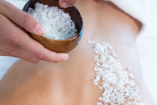Woman enjoying a salt scrub massage
